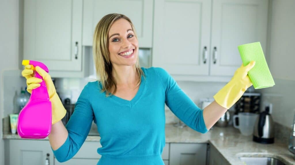 stay at home mom cleaning the kitchen happy