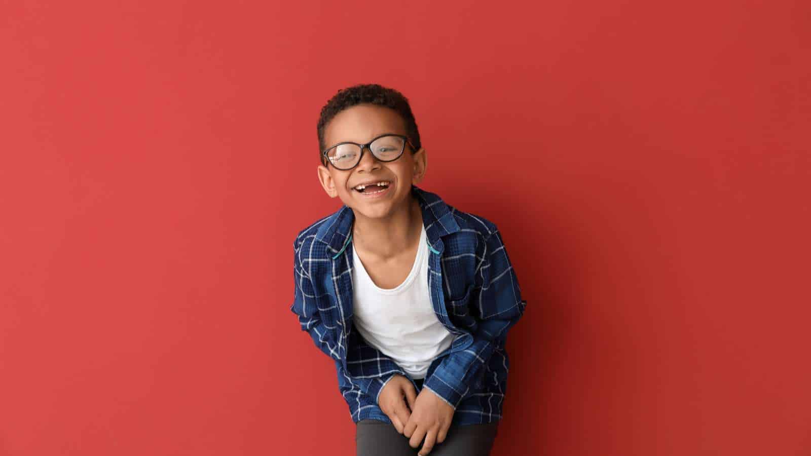 kid laughing with red background