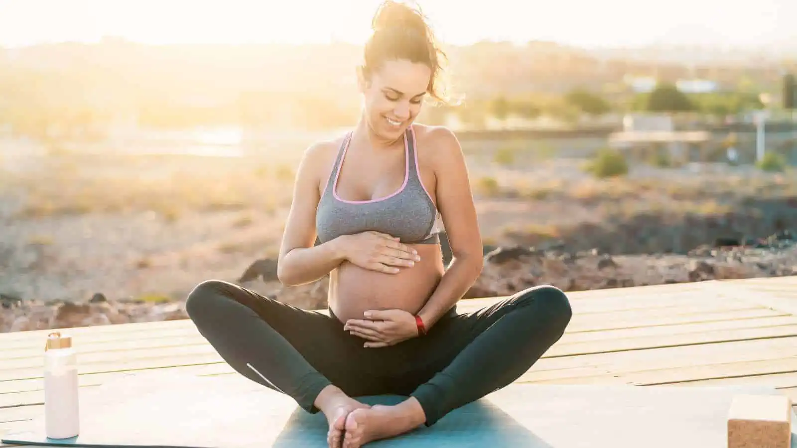pregnant woman on yoga mat