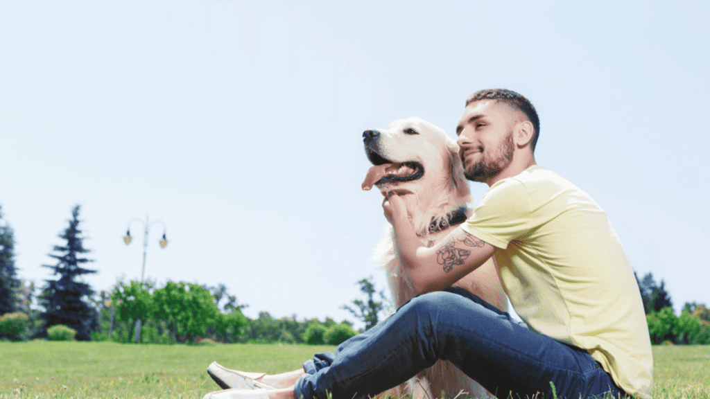 man with his dog golden retriever park happy