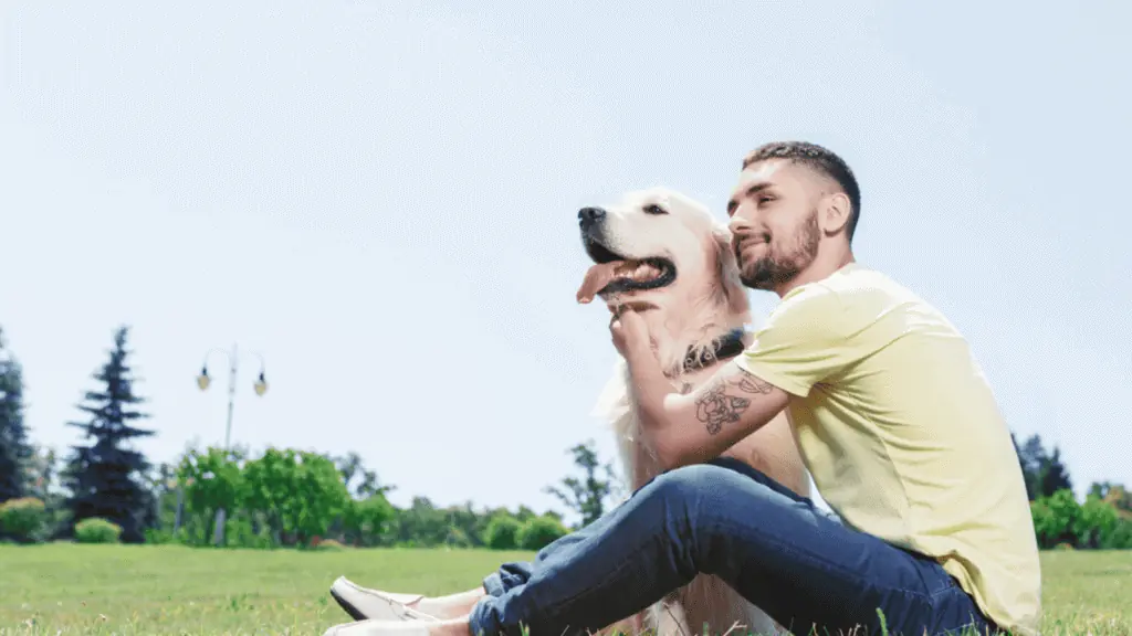 man with his dog golden retriever park happy