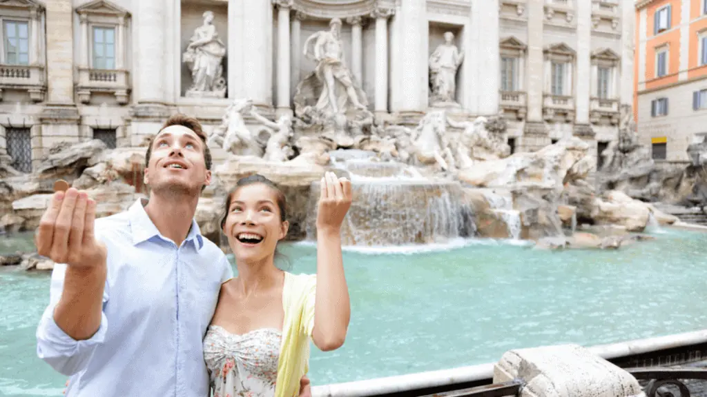 couple travel rome italy wishing well