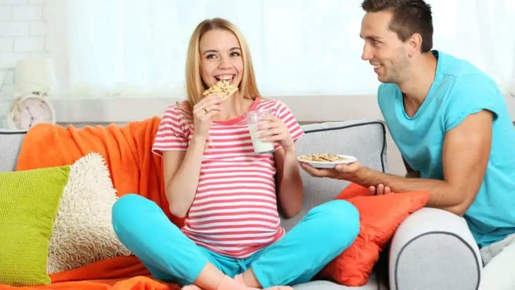 pregnant woman eating crackers