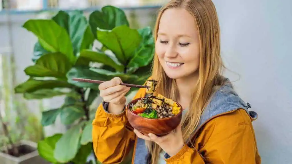 woman eating a bowl of food