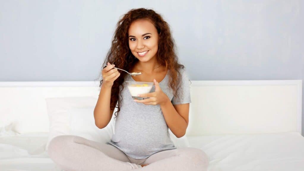 pregnant woman eating cereal
