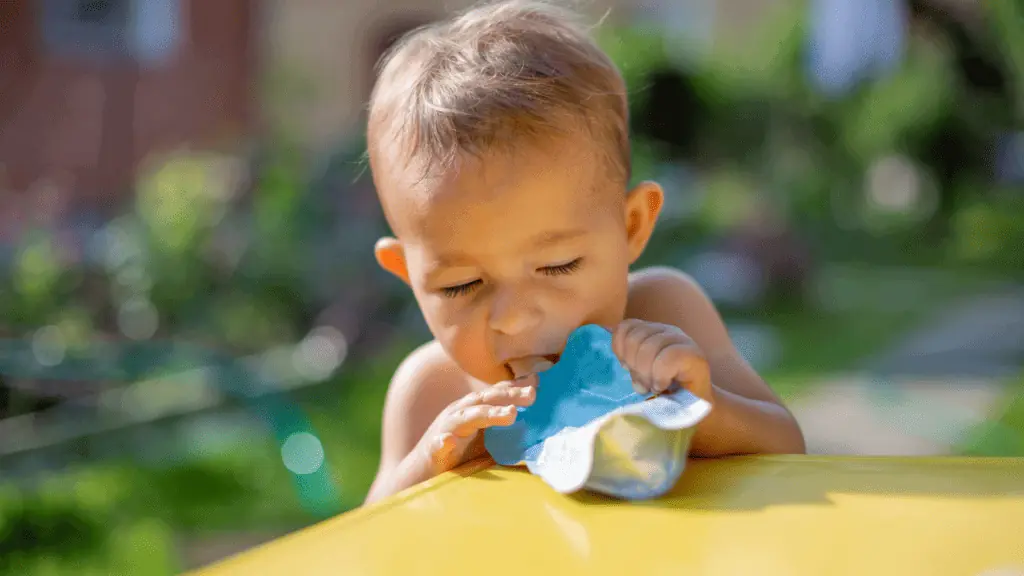 little boy toddler eating applesauce food pouch