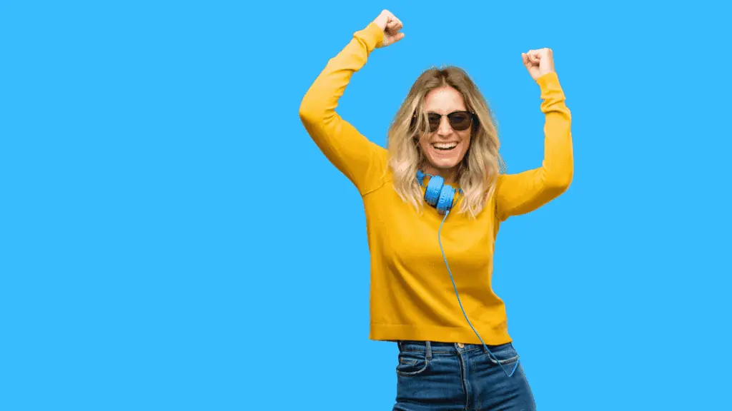 happy woman headphones yellow sweater yes