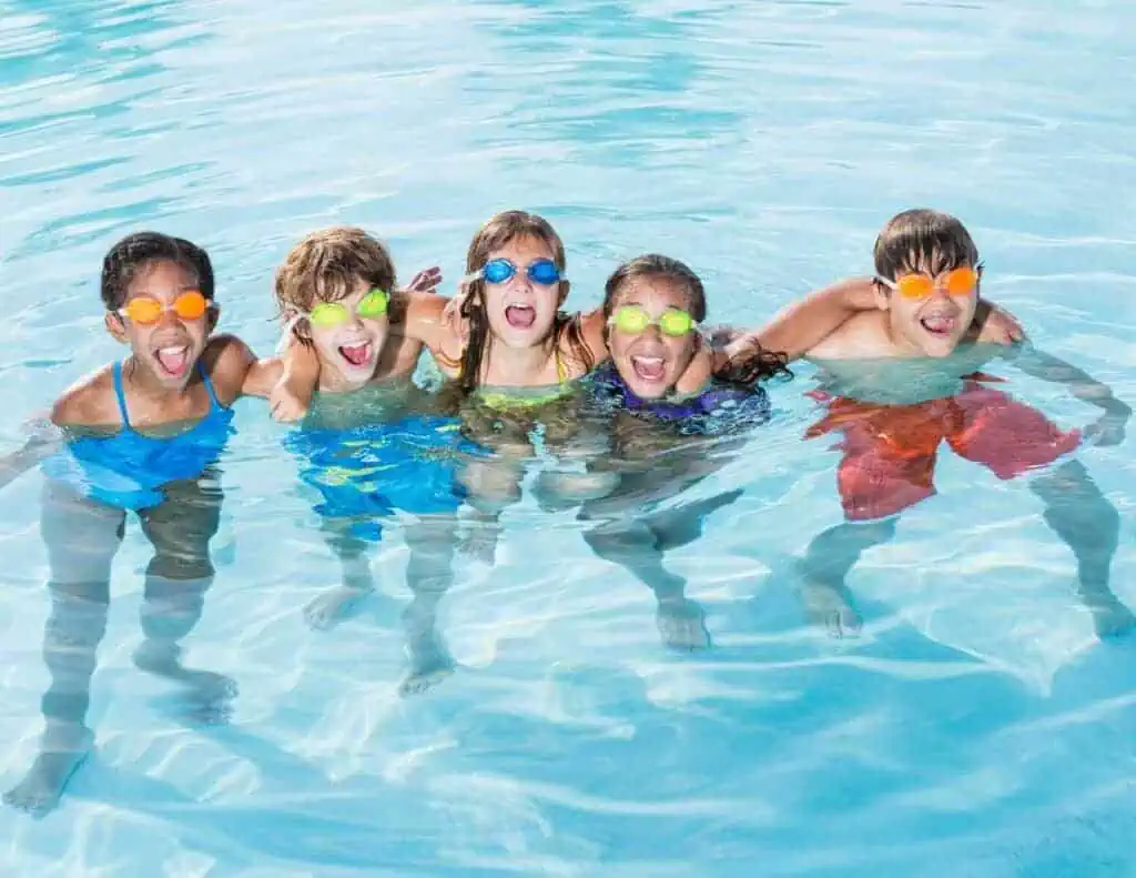 group of kids in the pool swimming