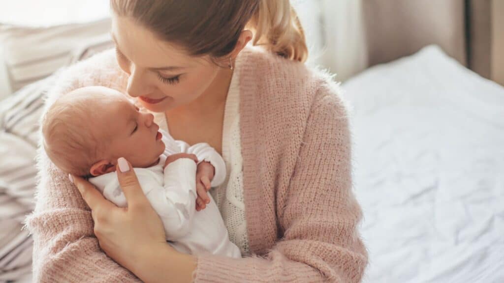mom holding baby- be your own advocate and enjoy your newborn