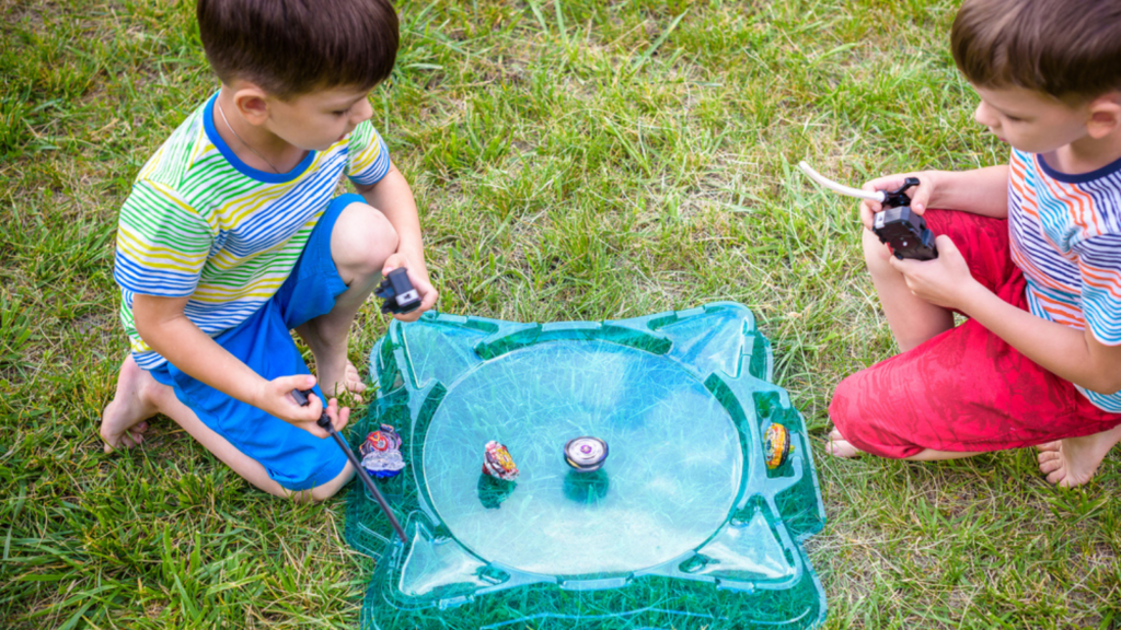 beyblades boy playing a game spinner
