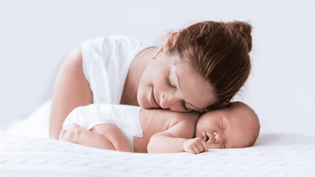 happy mom and sleeping newborn baby