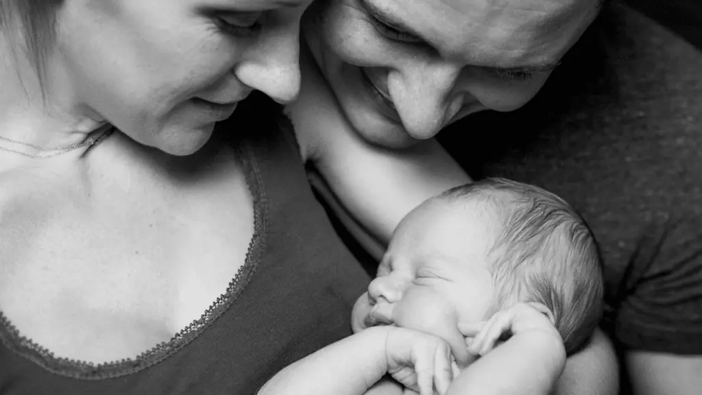 newborn baby with mom and dad happy