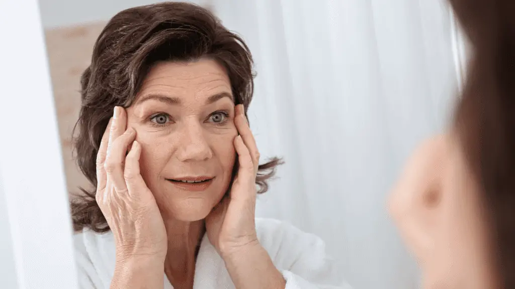 older woman looking at her wrinkles