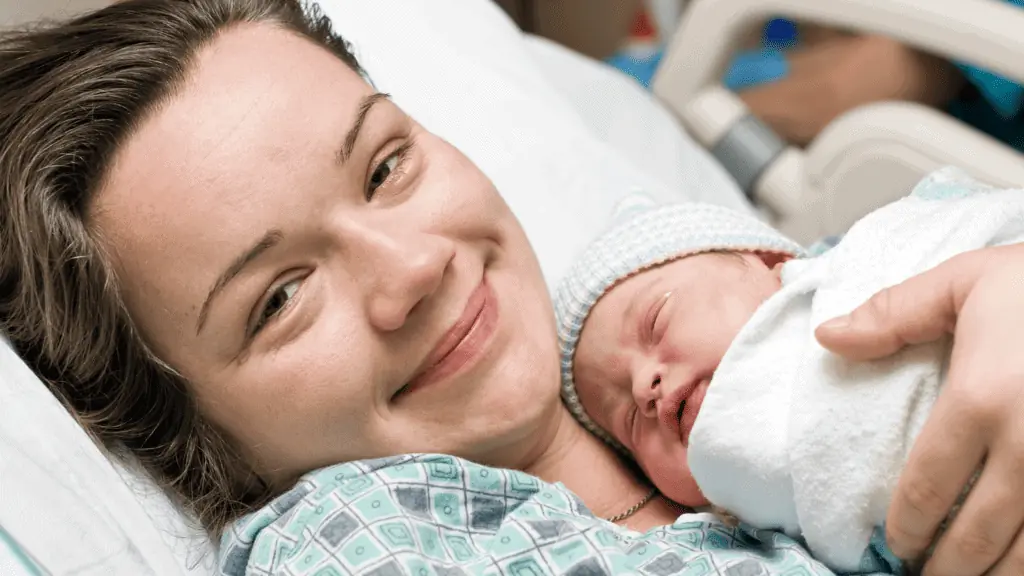 newborn baby and mom in the hospital happy