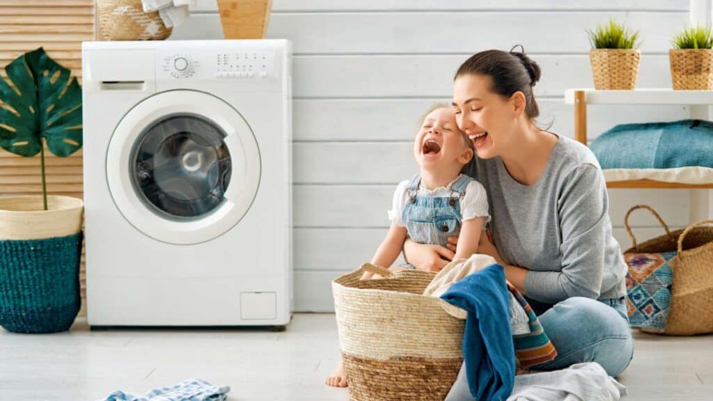 mom and kid laughing with laundry