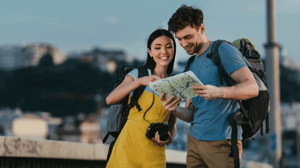 couple happy traveling with a map tourist explore