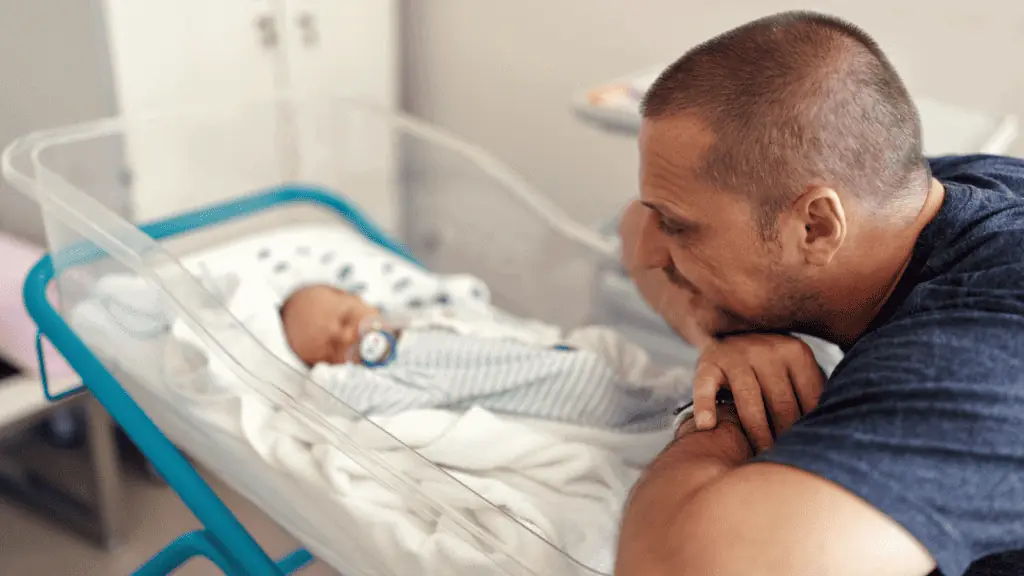 dad with newborn at the hospital pacifier