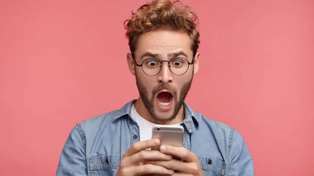 shocked man with cell phone
