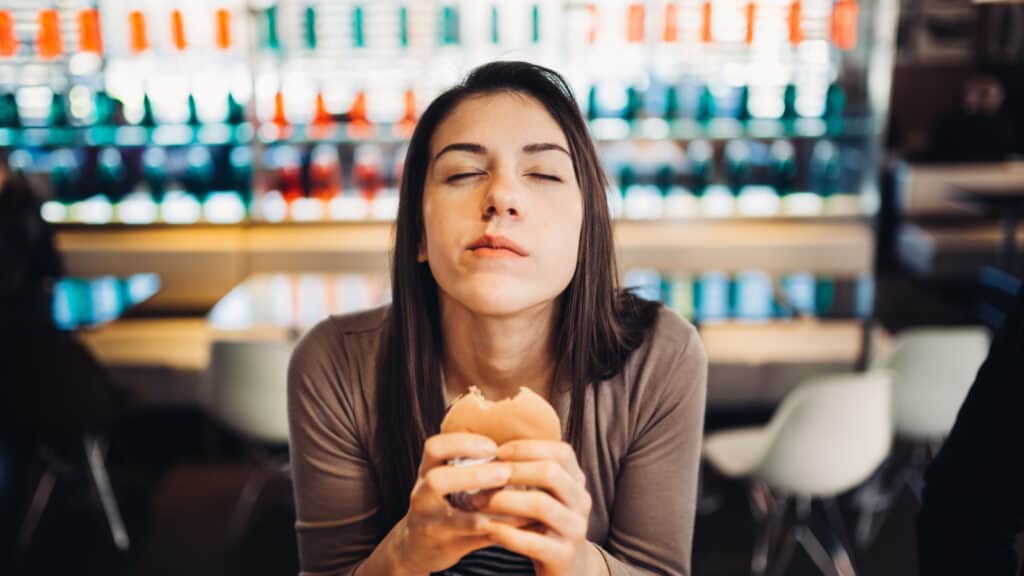 woman enjoying a burger