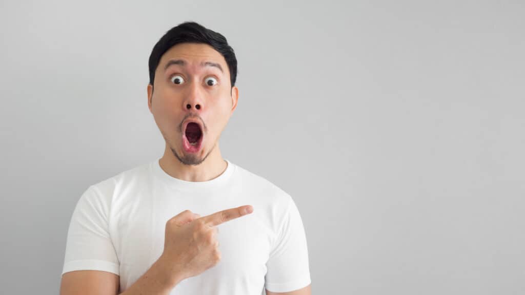shocked asian man pointing his finger