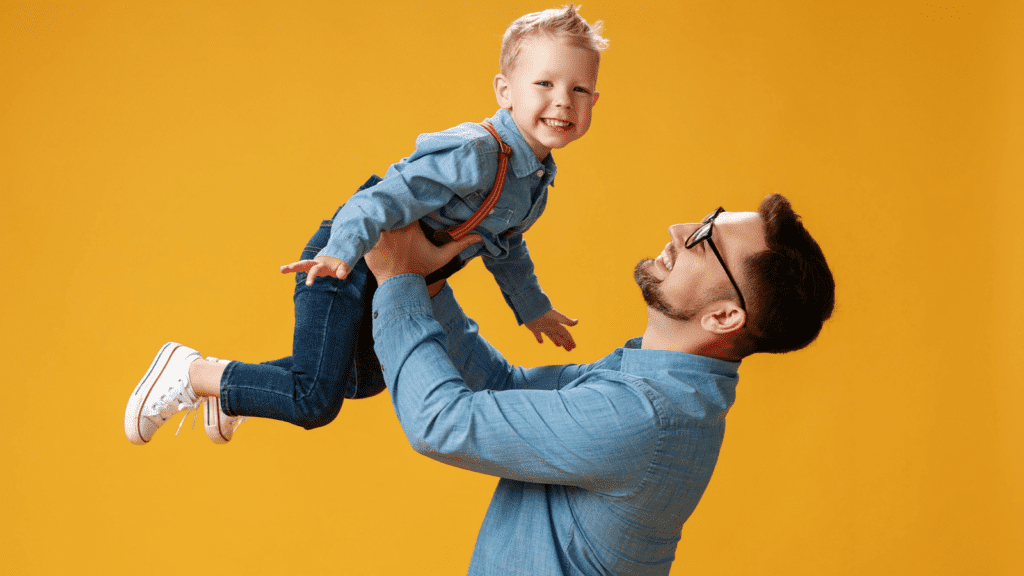dad holding son in air