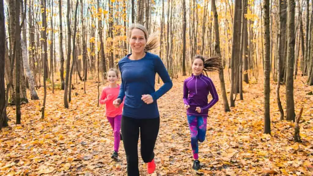 mom running with girls in woods