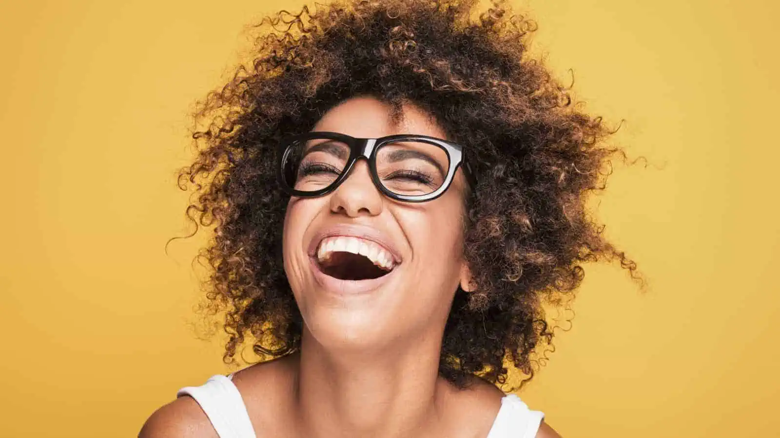 woman in glasses laughing
