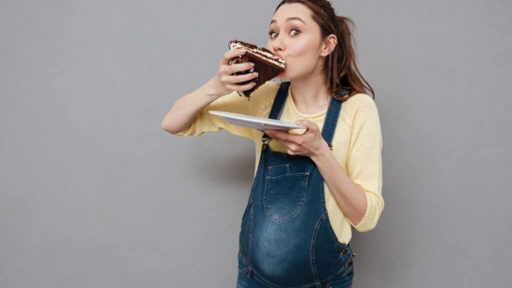 pregnant woman eating cake