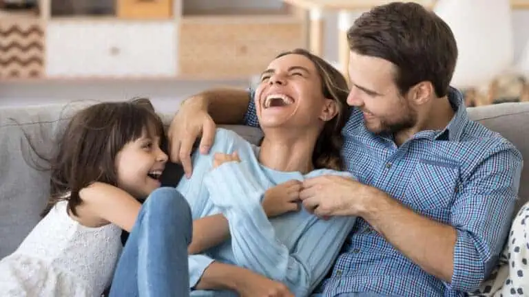 family laughing on the couch