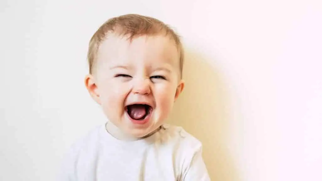 cute baby laughing with mouth open