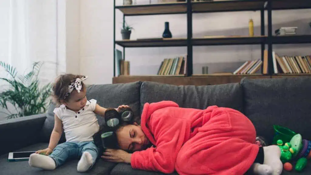 mom sleeping on the couch with hair rollers