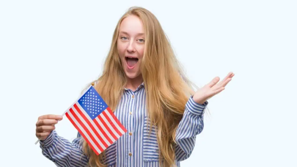 Blonde teenager woman holding flag of United States of America