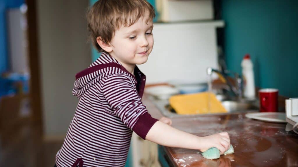 Boy cleaning the kitchen