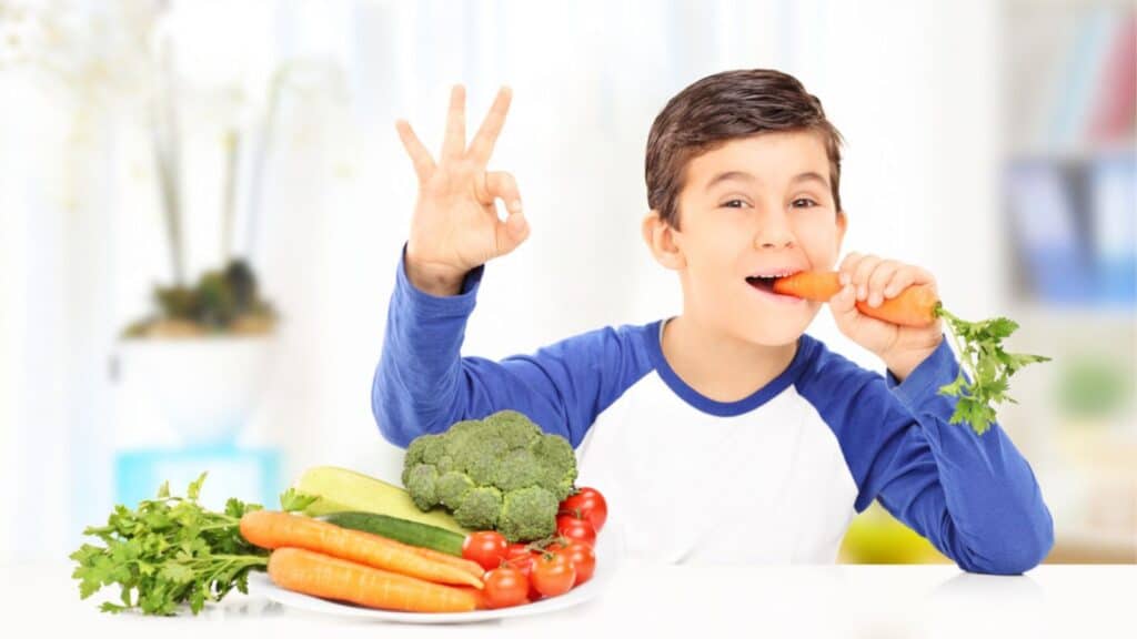 Boy eating vegetables