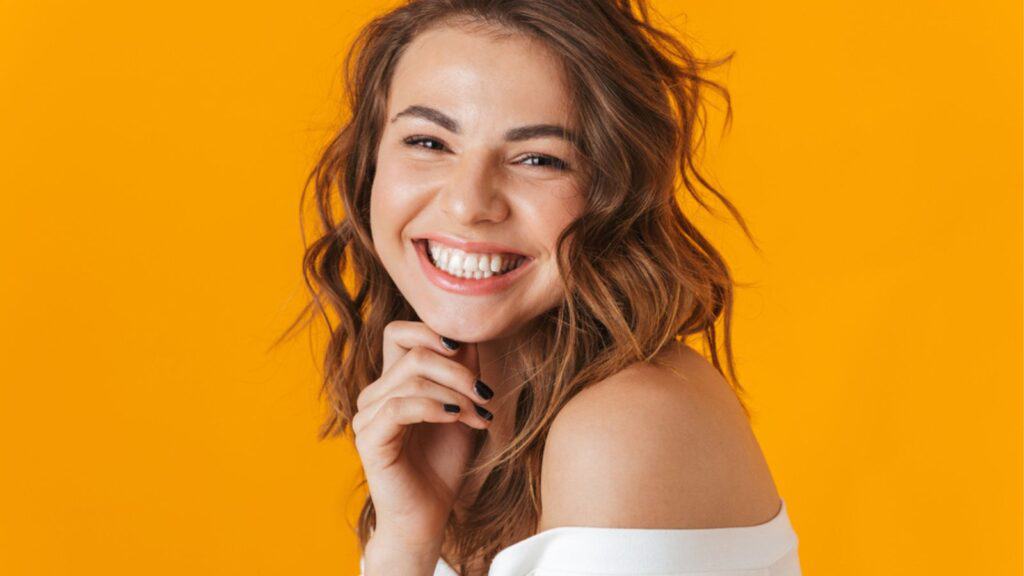 Cheerful happy young woman wearing white shirt