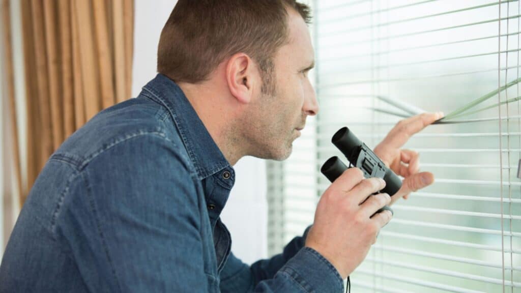 Close up of man looking through the window