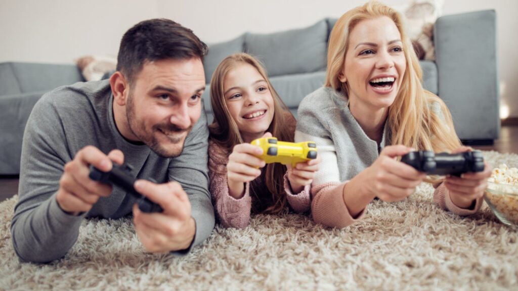 Competitive young family playing video games in living room
