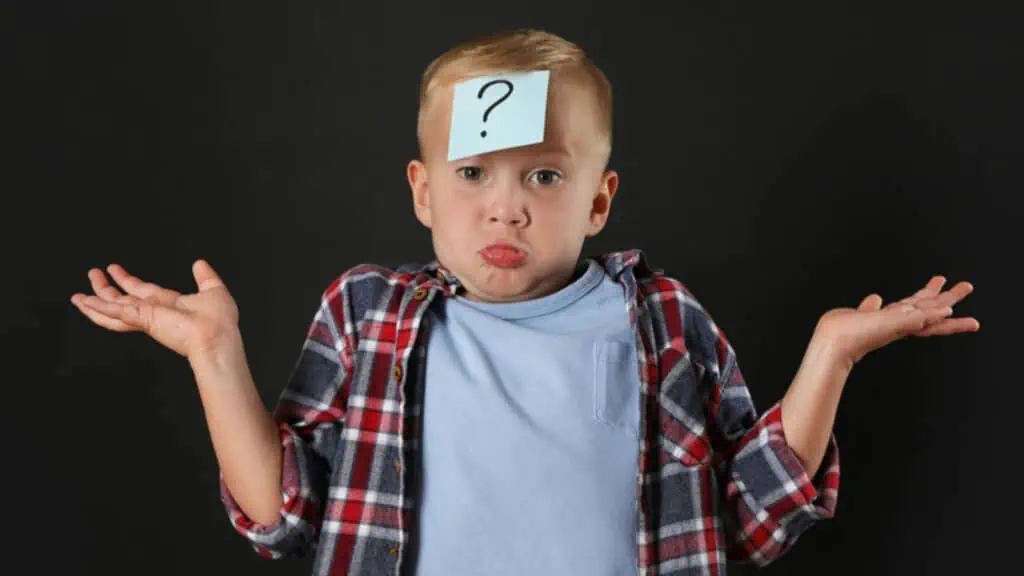 Confused boy with question mark sticker on forehead