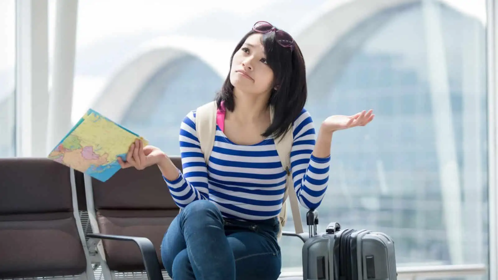 Confused woman traveler holding map
