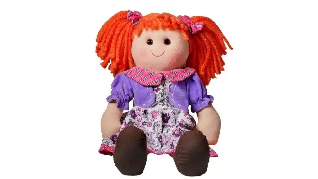 Curly cute rag doll toy smile and sit isolated on white