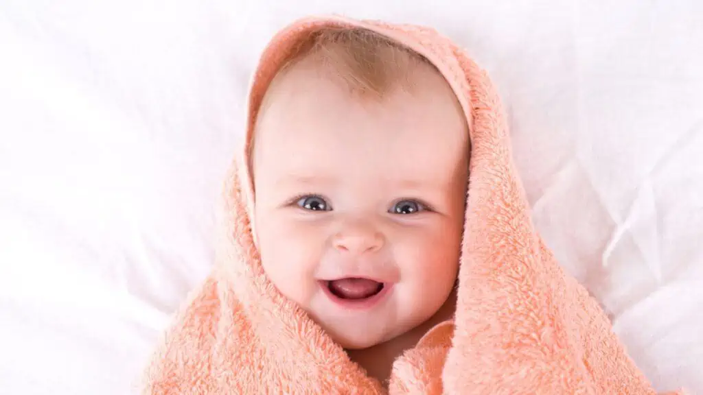 Cute baby with color peach towel