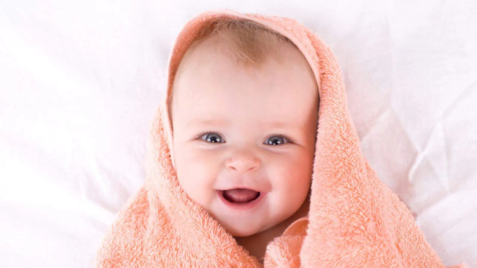 Cute baby with color peach towel