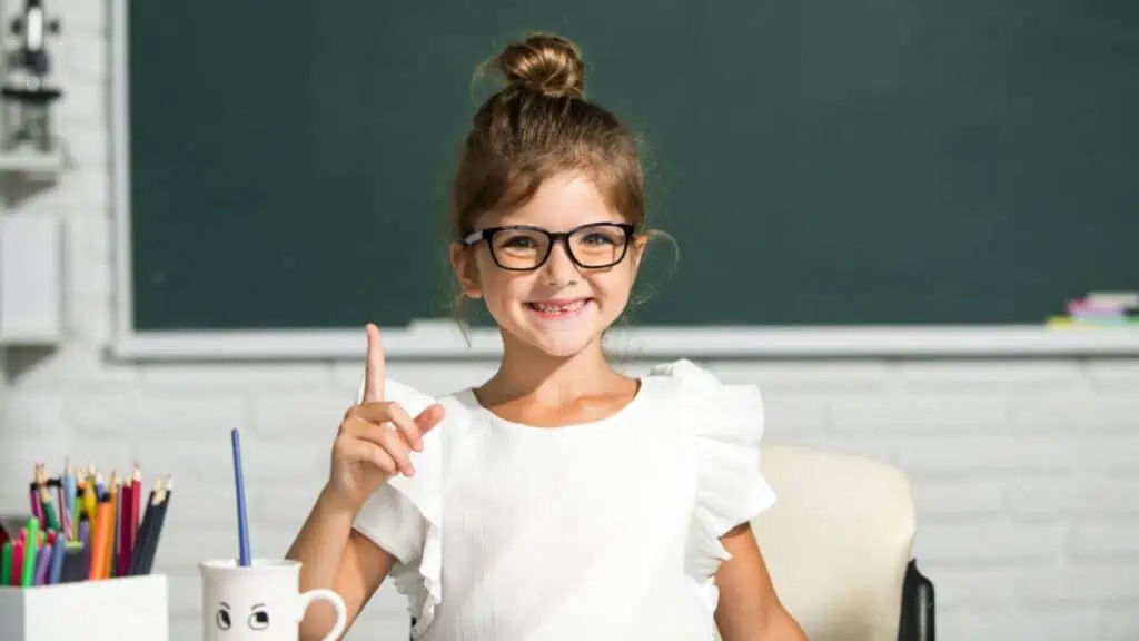 Cute little girl child painting with paints color and brush