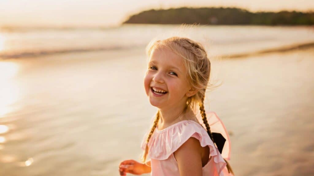 Cute little girl walking on the beach