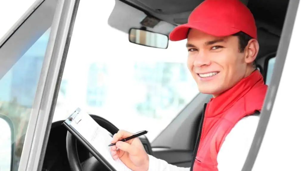 Delivery driver man with clipboard in delivery service van