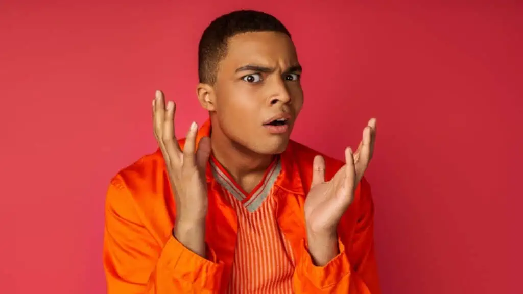 Displeased, shocked african american in orange shirt