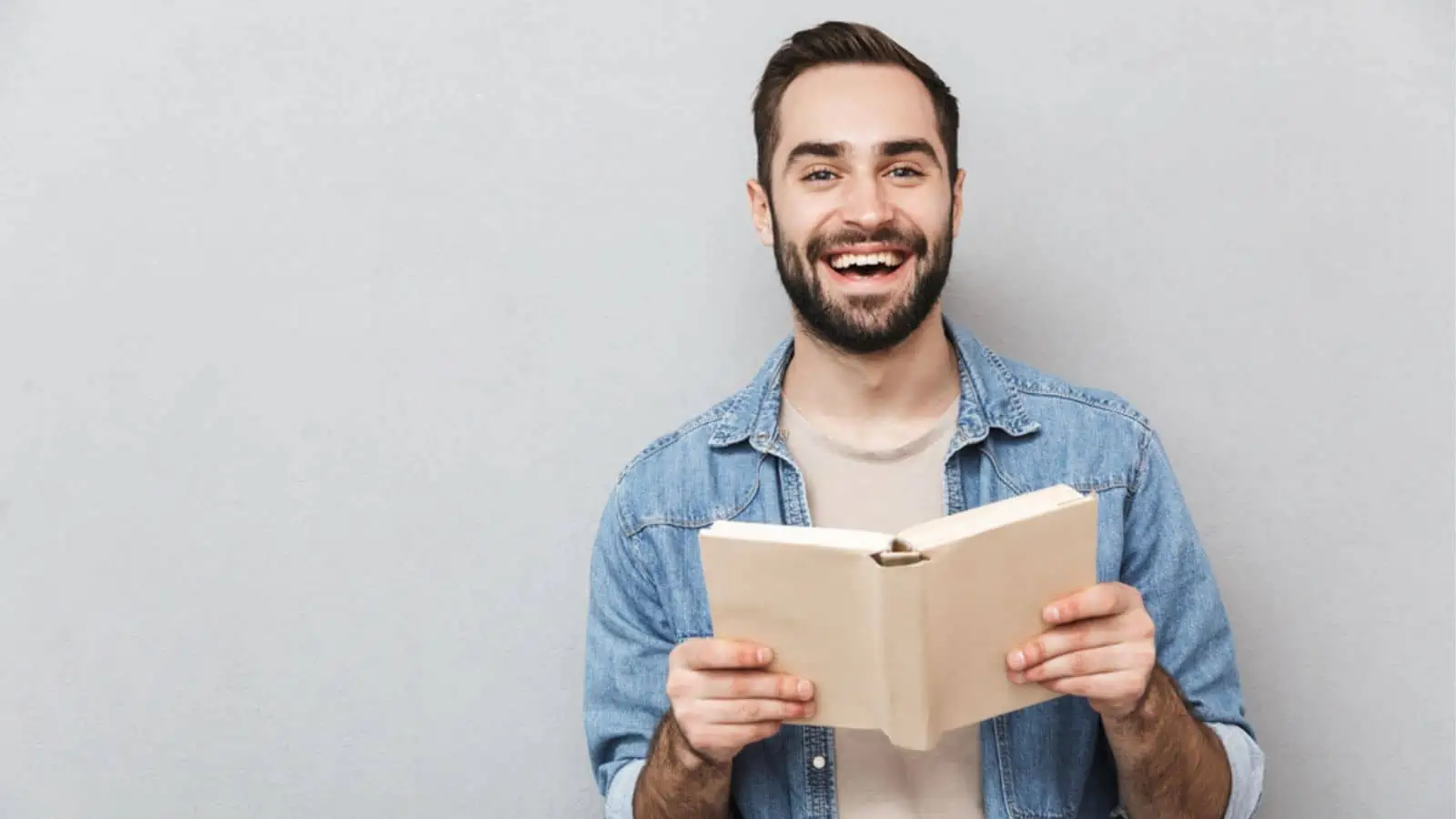 Excited cheerful man wearing shirt standing