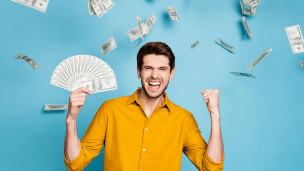 Excited ecstatic cheerful emotional man with blue background