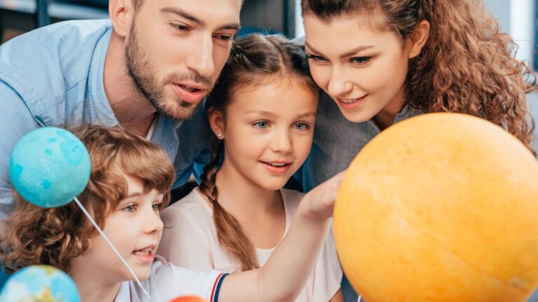 Family exploring solar system model
