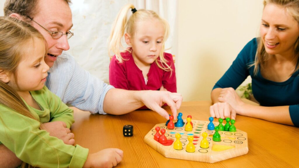 Family playing a board game and a dice